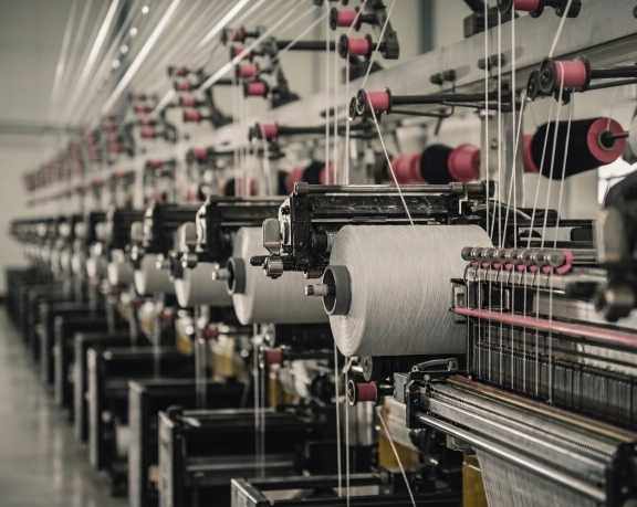 Row of industrial knitting machines in production
